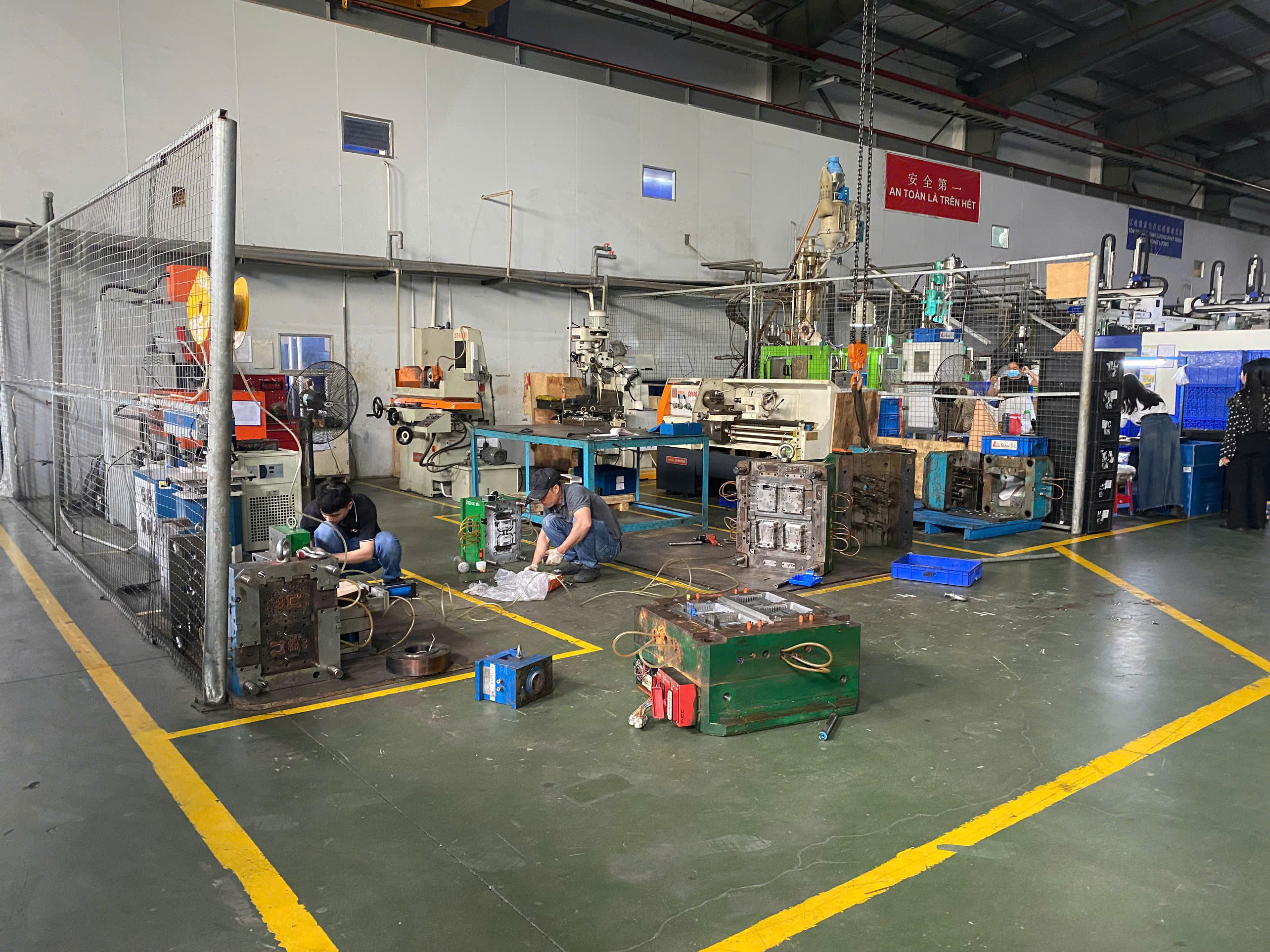Technician performing maintenance on injection mold.jpg